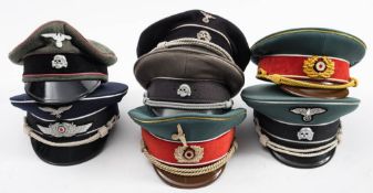 A group of seven reproduction German Officers peaked caps: