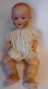 An Armand Marseille bisque head doll: impressed A.M. Germany. 518./9.
