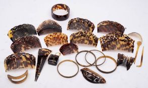 A collection of various tortoiseshell hair combs: and grips