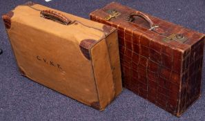 An early 20th century brown crocodile leather ladies suitcase with canvas travel cover and initials