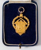 A 9ct gold shooting trophy pendant inscribed and dated 'Bisley 1939':