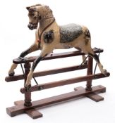 An early 20th century rocking horse by Balfours: the carved head inset with glass eyes with open