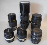 A collection of six Nikon camera lenses: including;- Nikkor 300mm 1:4.