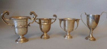 Four small silver trophy cups, various makers and dates: awarded to H.M.