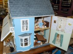 A large late 20th century Victorian style doll's house: with simulated slate roof over blue wall