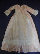 A Regency period girl's pink silk dress: with high waisted panel front with applied lace panels,