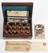 An early 20th century set of negative tinting colours in an associated mahogany box: together with