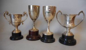 Four assorted silver trophy cups, various makers and dates; inscribed,