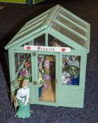 A 20th Century doll's greenhouse flower shop 'Poppies' with figure, flowers and accessories.