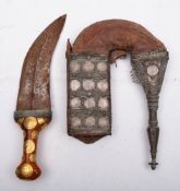 A gilt and coin mounted amber handled jambiya,