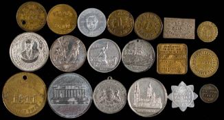 A collection of whitemetal and brass tokens etc.