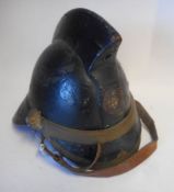A leather and brass mounted fireman's helmet: with leather liner and chin strap.