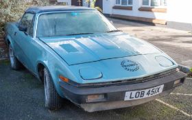 A 1981 Triumph TR7 convertible: registration 'LOB 451X', blue with black roof,