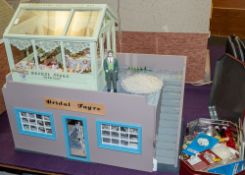 A 20th Century doll's shop 'Bridal Fayre' with green house cake shop above, together with figures,