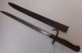 A 1907 MK1 bayonet: with 43cm fullered blade, hooked quillion and wood slab grips,