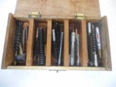 A wood box containing assorted rifle cleaning equipment: including broken .
