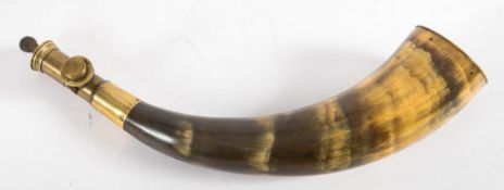 A brass mounted horn powder flask: unsigned with dram measure and pinned body,