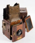 A mahogany and brass Ensign Popular reflex 'Tropical Model' three quarter plate camera: fitted