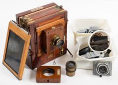 A mahogany and brass half plate camera by W.