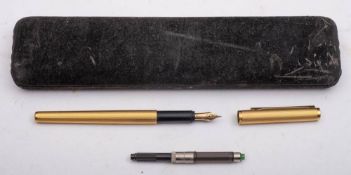 A Dunhill gilt metal fountain pen: with 14k gold nip and machine finish
