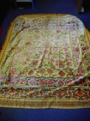 A Middle Eastern silk & wool throw: with central foliate cartouche and flowerheads to a mustard