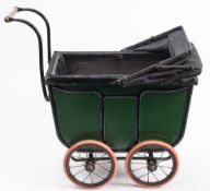 A Victorian/Edwardian child's dolls pram: of rectangular outline, with green and black coachwork,