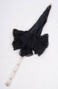 A Victorian parasol with ivory handle,