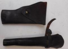 A leather holster: a stitched leather bugle holster and Indian percussion cap carbine.