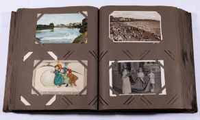 An album of assorted Edwardian and later postcards: includes humour, greetings, birthdays,