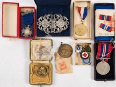 A WWII War Medal together with a collection of enamel badges etc.