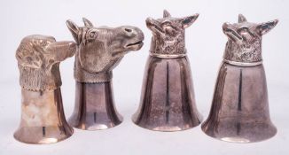 A set of four Continental silver plated stirrup cups: two with fox head decoration,