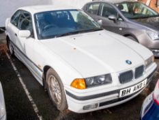 A 1998 BMW 323i automatic: registration 'R751 JAF', white with black cloth interior and sunroof,