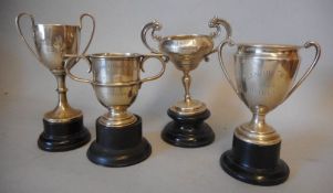 Four small silver trophy cups, various makers and dates: awarded to H.M.