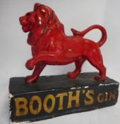 A Booths Gin advertising figure: the red painted plaster lion mounted on a rectangular base,