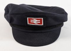 A British Rail peaked cap: together with a wooden rattle and an oil lamp (3)