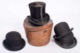 A black felt top hat by E Hawkins & Co, Weston Super Mare, in a brown leather top hat case: 54.