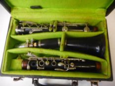 A Boosey and Hawkes four section Regent clarinet: with spare reeds, contained in a fitted case.