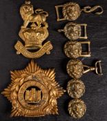 A Victorian brass Royal Marines valise badge: together with a Devon Light Infantry helmet plate and