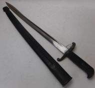 An 1855 Lancaster sword bayonet by Reeves: with 60cm single edged blade and chequered grip,