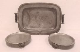 Nineteenth century large pewter hot plate with wooden handles and two antique pewter circular