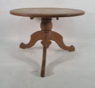 Modern circular pine breakfast table on three cabriole legs, 105cm diameter