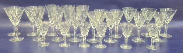 Set of twenty four Waterford cut wine glasses, all with panelled tapering bowls to include flutes