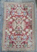 Crewelwork embroidered rug/wall hanging with foliate spray on red ground, orange border, 119cm x