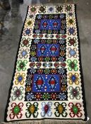 Eastern style ground, cream ground with blacks, blues, greens, yellows and reds