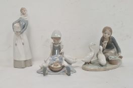 Lladro figure of a girl carrying lamb, 28cm high approx, another of girl seated with duck and