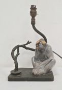 Ceramic monkey and metal table lamp, the monkey seated beside twisted branch on metal base, 19cm x