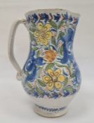 Continental faience pottery large jug with blue, yellow and orange floral and foliate decoration,