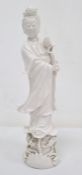 Modern Chinese blanc-de-chine Quan Yin holding a lotus flower and on base with further applied lotus