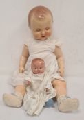 Small composition baby doll and another larger composition doll (2)