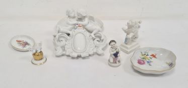 Meissen white porcelain cherub group, damaged, Nymphenburg porcelain lion with shield, Rosenthal cat